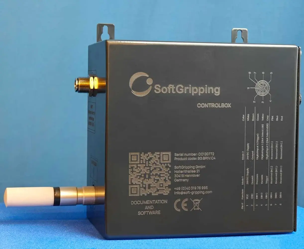 side view of a dark grey SoftGripping vacuum control unit showing QR code and connection details