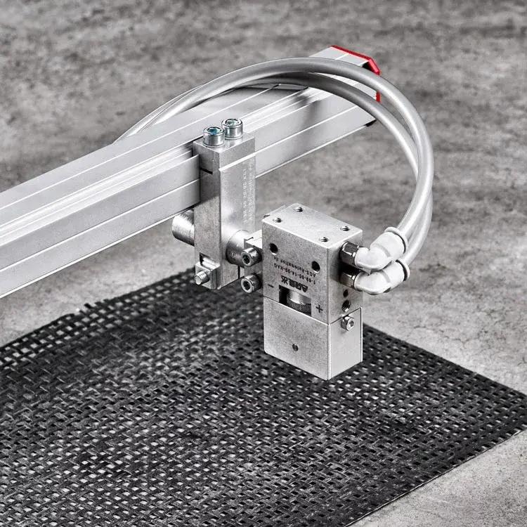 AGS Textile Gripper Pneumatic mounted on rail with tubes facing right, on textured surface