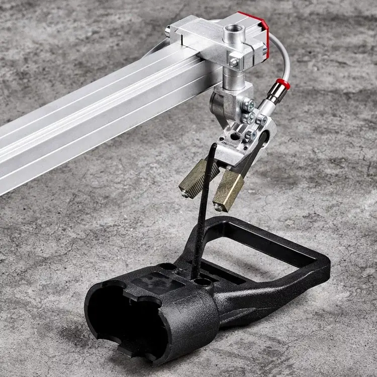 AGS Pneumatic Gripper mounted on a surface with a concrete floor background