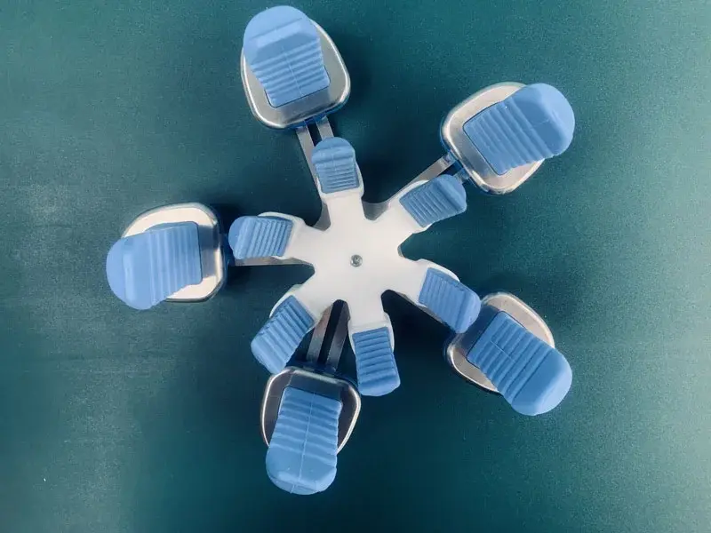 Top view of the assembled robot end effector with blue pneumatic soft gripper fingers