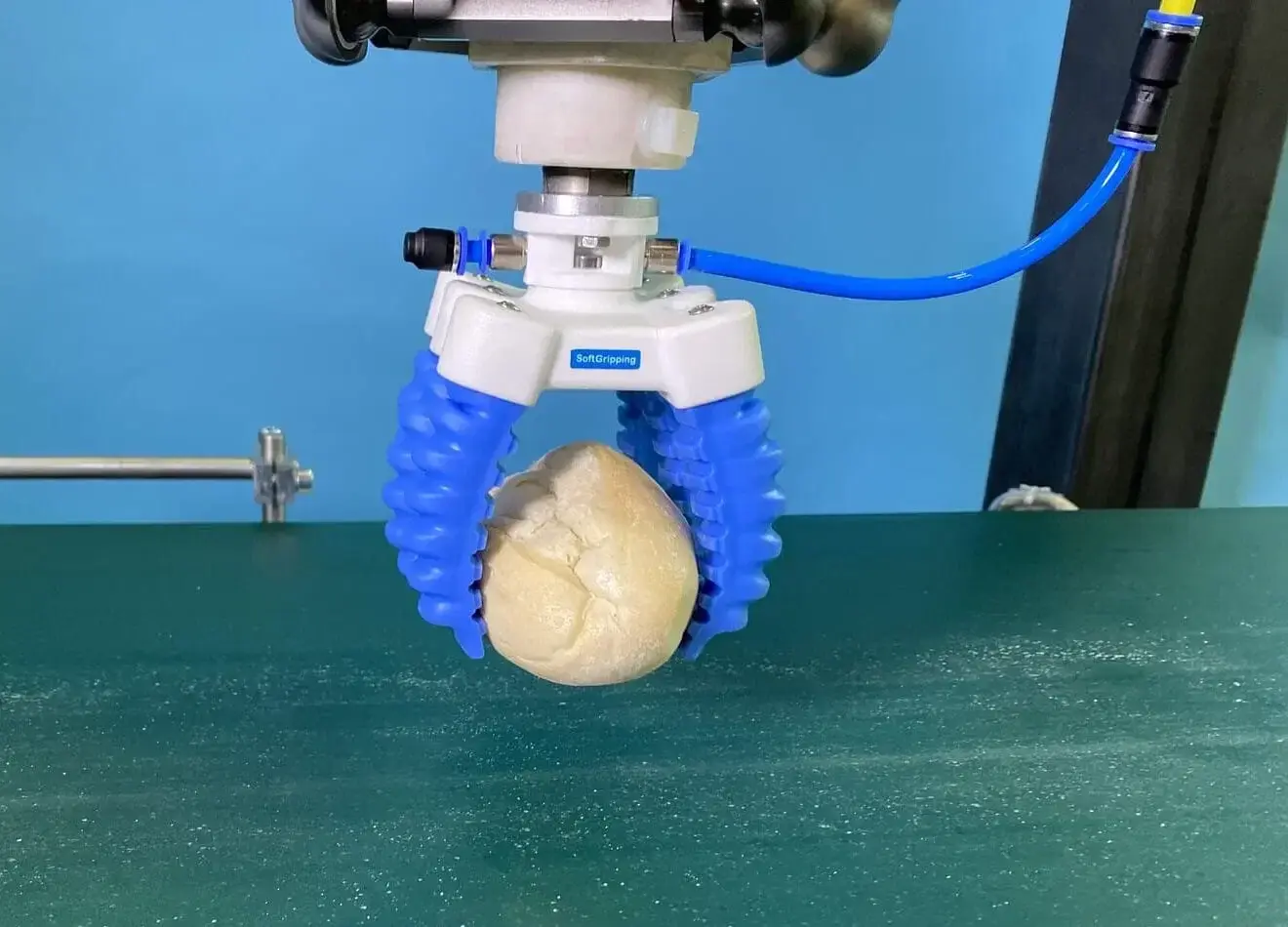 front view of robot end effector soft gripper holding an object