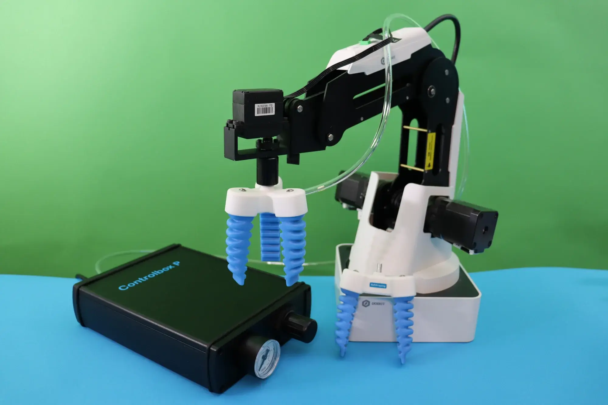 Controlbox P-V with vacuum pump placed next to robotic arm with soft gripping fingers