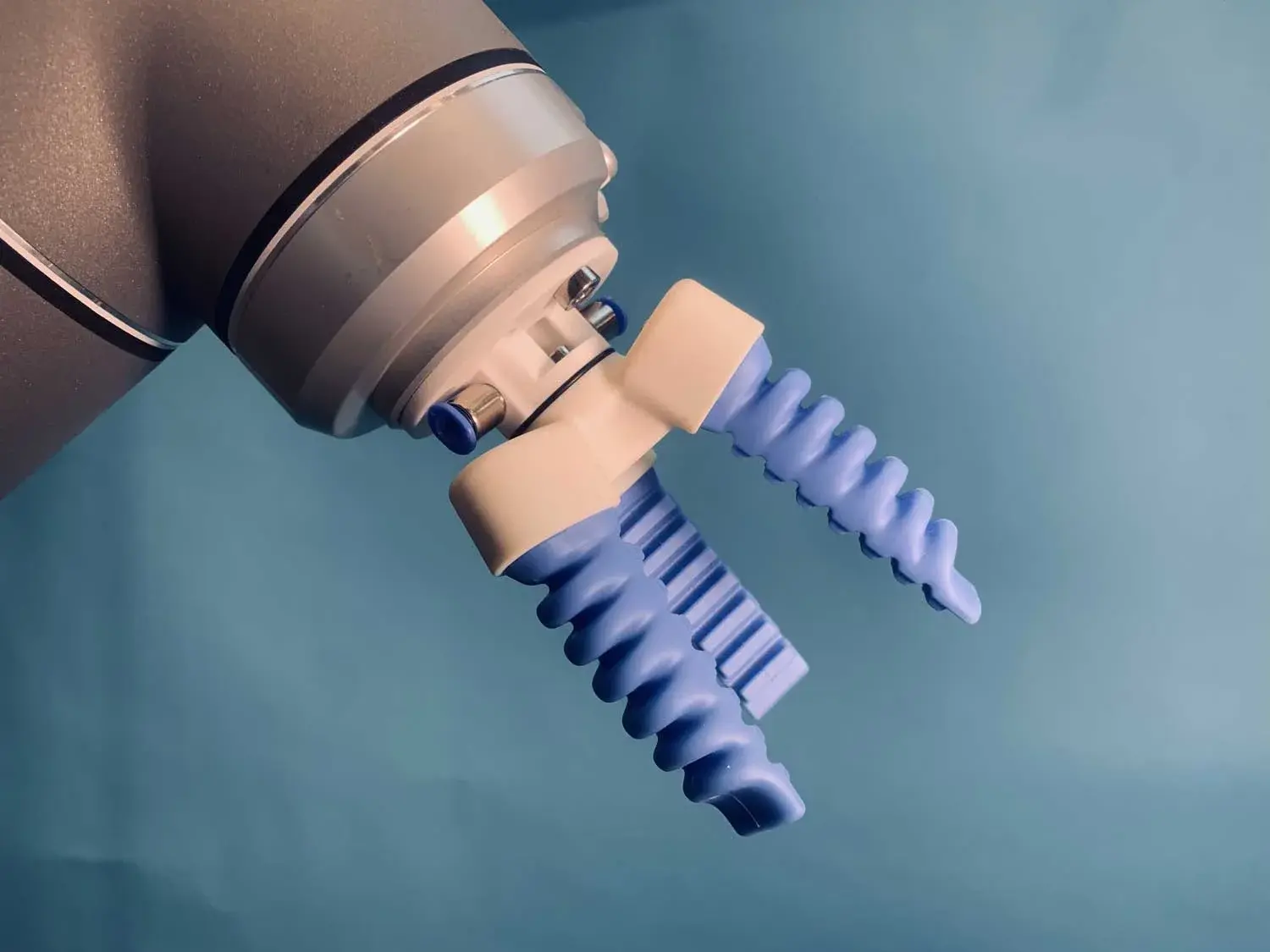 SoftGripping three finger centric gripper mounted on a robot arm, side view