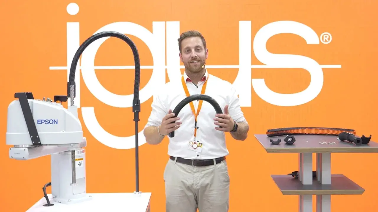 Cable guidance system mounted on Epson robot with person holding a part