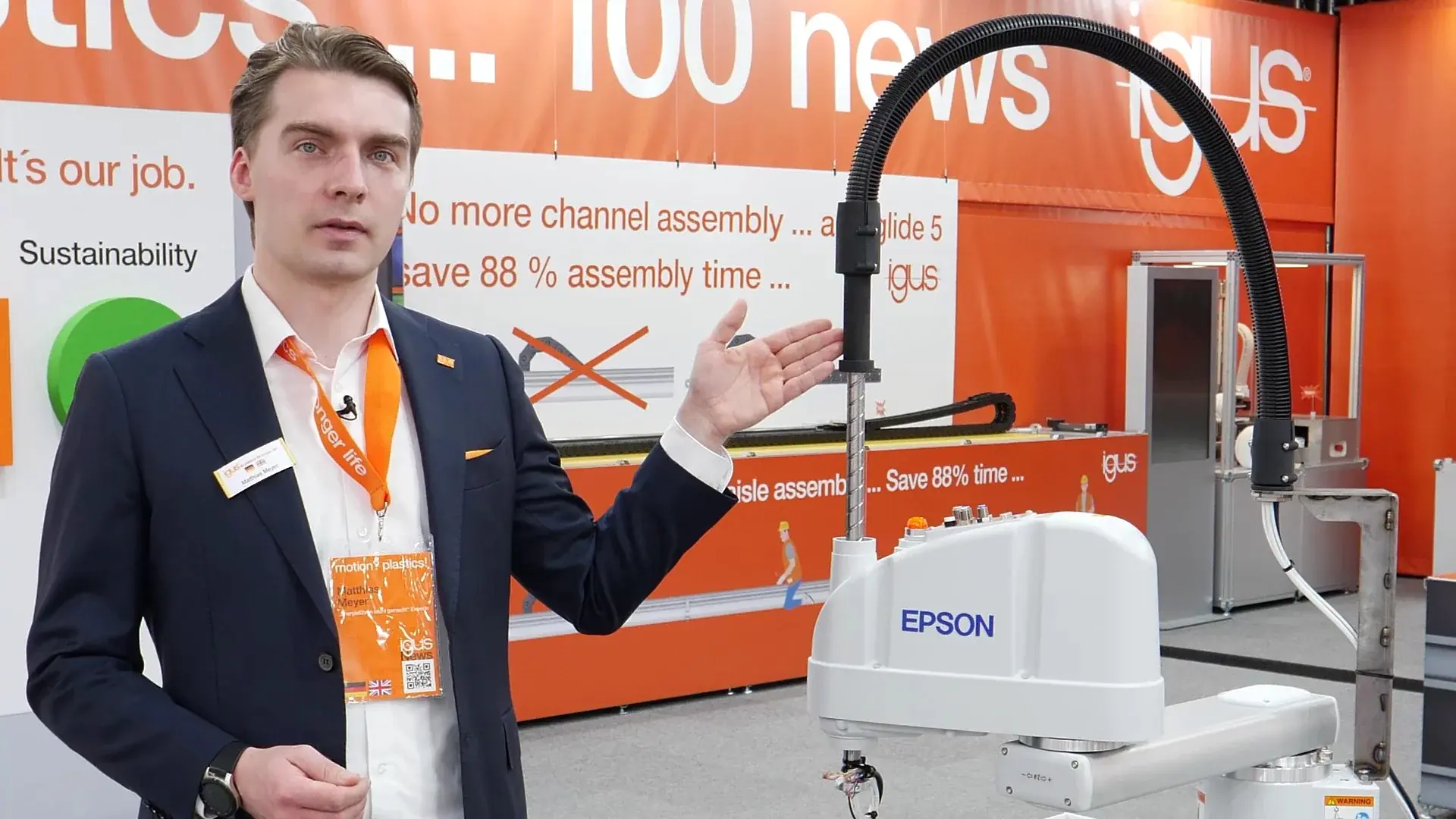Side view of EPSON T6 SCARA robot with igus e-rib cable guidance system next to a man