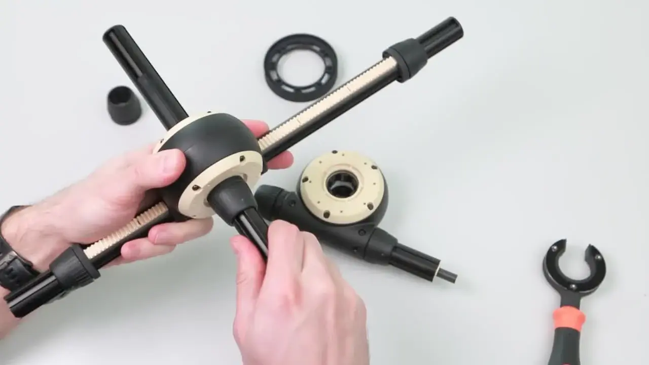 Hands assembling igus Apiro Robotic Kit RL-A9.0200 modular segment on a table