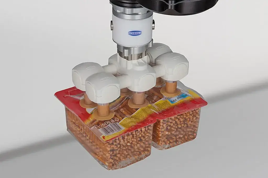 Schmalz VEE Vacuum Gripper Kit with four fingers gripping plastic containers
