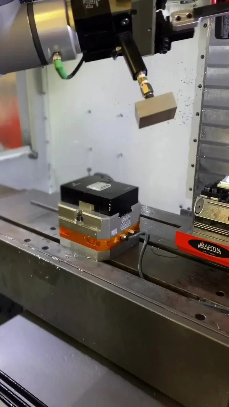 Air vise table vise mounted on a machine bed with tool above