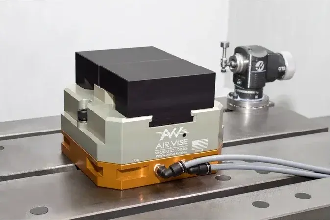 Air Vise Table Vise mounted on a metal surface with hoses connected