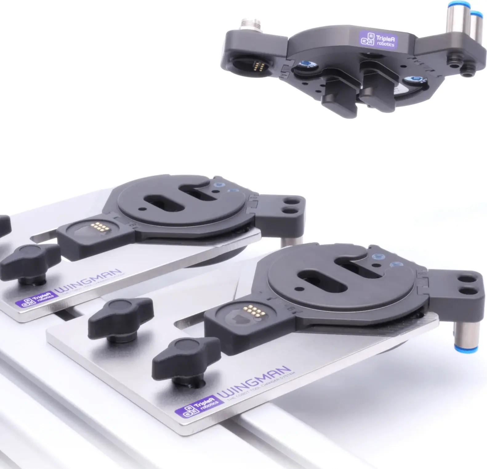 angled close-up of two WINGMAN automatic tool changers with connectors on white surface