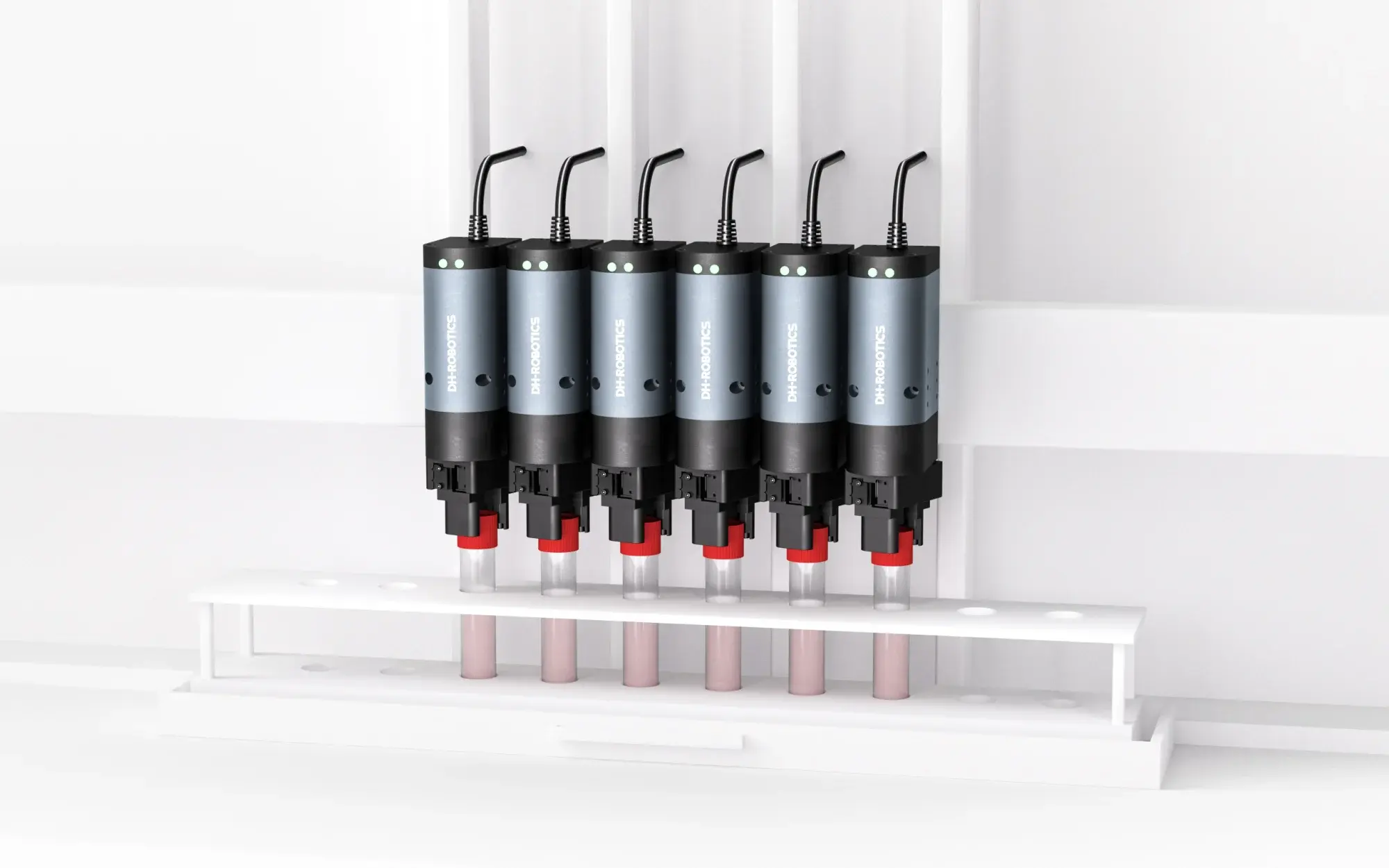 front view of six rotary grippers mounted in a row with connected cables