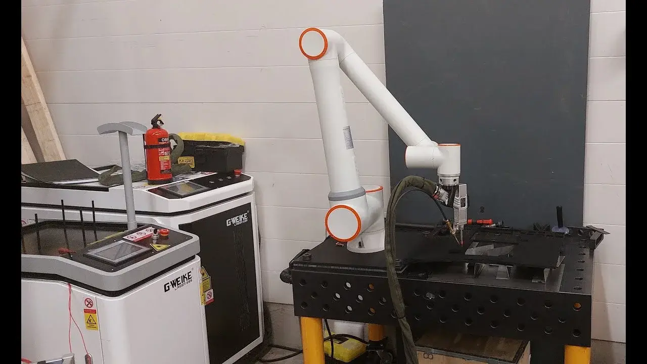 Fairino FR30 Cobot mounted on a table, operating in a workshop environment
