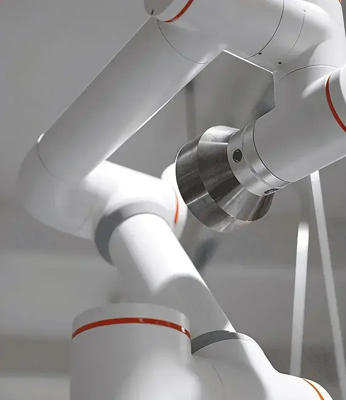 close-up of the arm joints and metal joint cover on a white robotic arm with orange accents