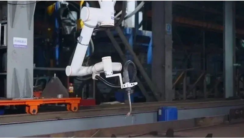 Fairino FR10 robot arm mounted in an industrial setting performing a task